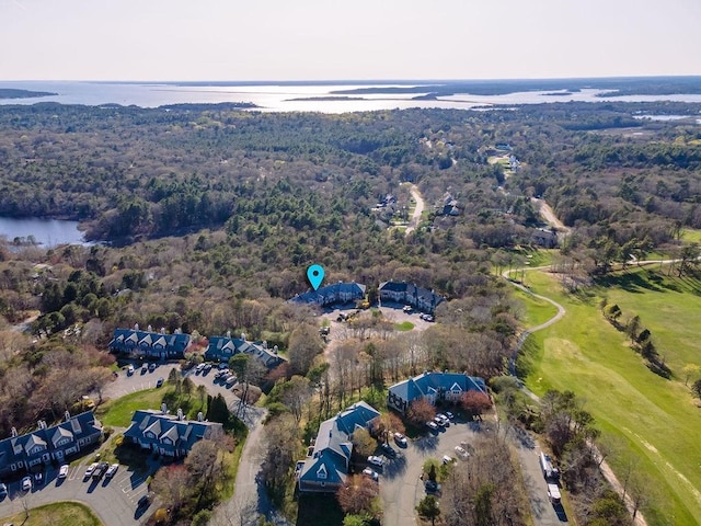 birds eye view of property with a water view, golf course view, and a wooded view