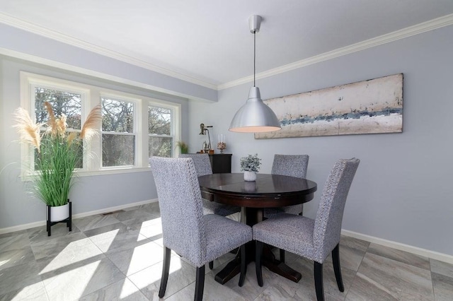 dining area featuring baseboards and ornamental molding