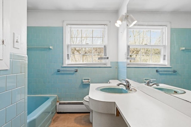 bathroom with tile walls, baseboard heating, toilet, and vanity