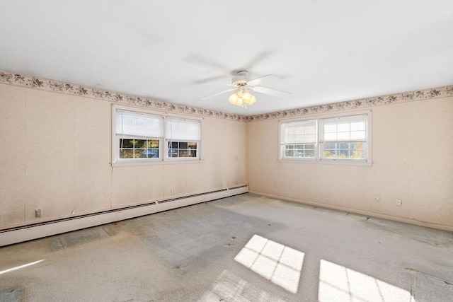 carpeted spare room with a baseboard heating unit and ceiling fan