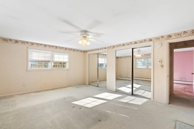 spare room with a baseboard heating unit, ceiling fan, and light carpet