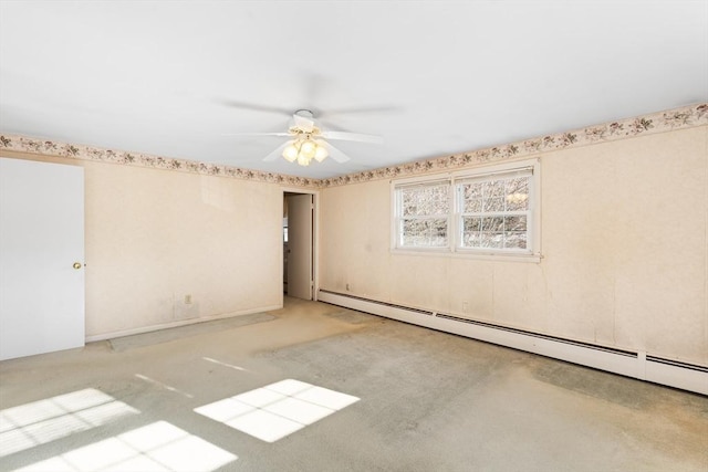 carpeted empty room featuring ceiling fan and a baseboard radiator