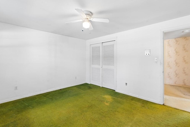 unfurnished bedroom featuring ceiling fan, a closet, and dark colored carpet