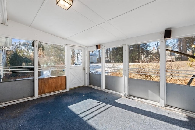 unfurnished sunroom featuring vaulted ceiling