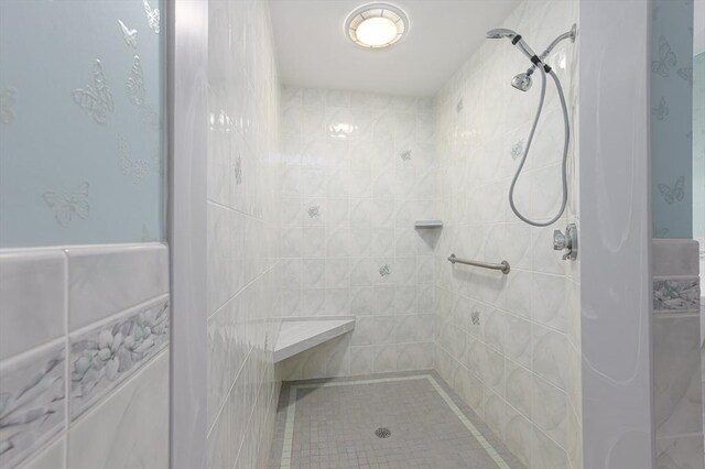 full bath with a tile shower