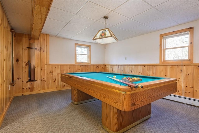 recreation room featuring a drop ceiling, carpet floors, wood walls, and wainscoting