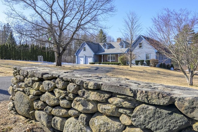 view of yard with a garage and driveway