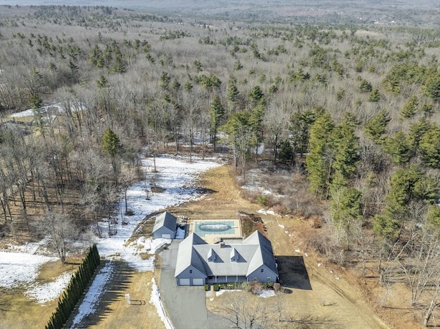 drone / aerial view featuring a wooded view