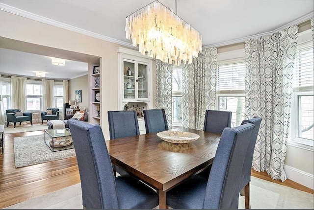 8 Cambridge Ter Unit 2, Cambridge, MA 02140 - dining space featuring ornamental molding, wood finished floors, a chandelier, and baseboards