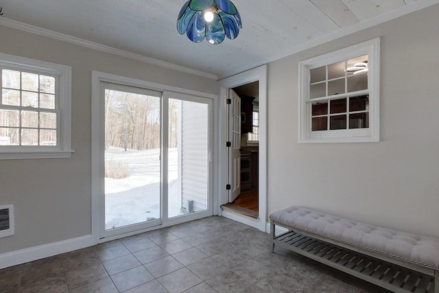 doorway featuring crown molding, baseboards, and tile patterned floors