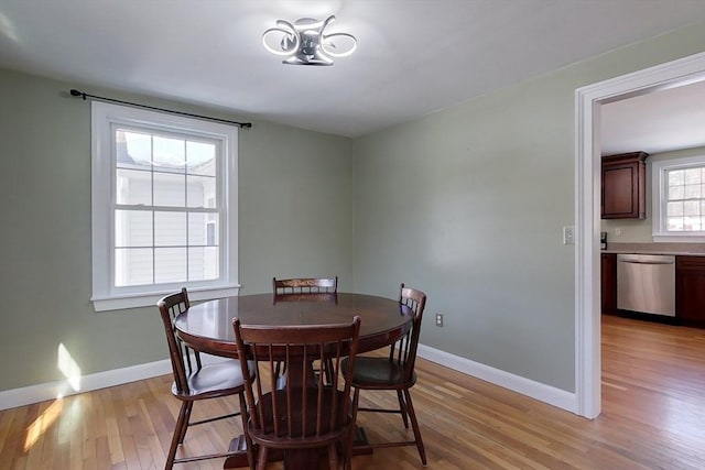 dining room with light wood-style flooring and baseboards