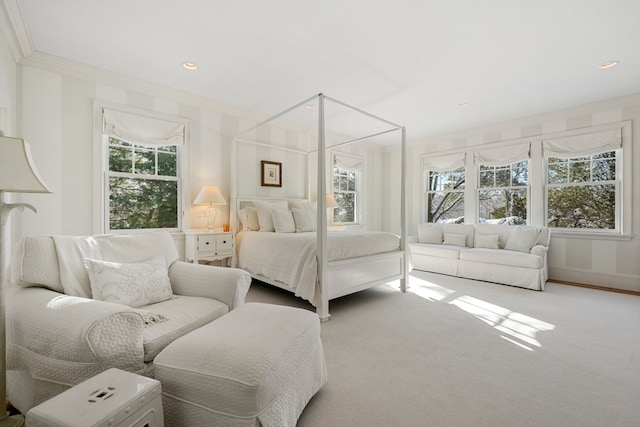 carpeted bedroom with multiple windows and crown molding