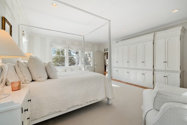 bedroom with ornamental molding and carpet