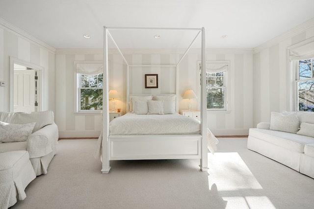 carpeted bedroom with ornamental molding and multiple windows