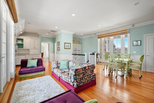 living room featuring crown molding and light wood-type flooring