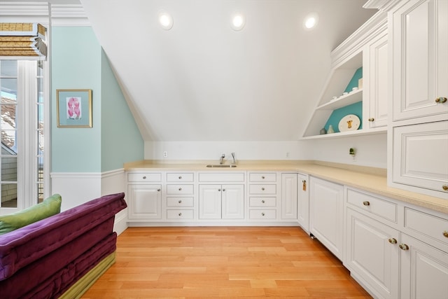 interior space with light hardwood / wood-style floors, sink, and lofted ceiling