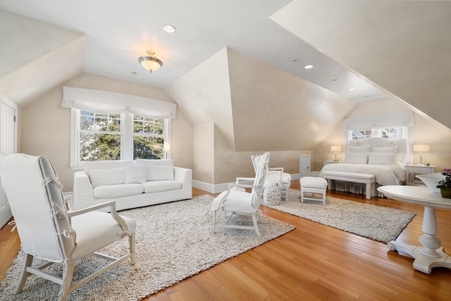 living room with lofted ceiling and light wood-type flooring