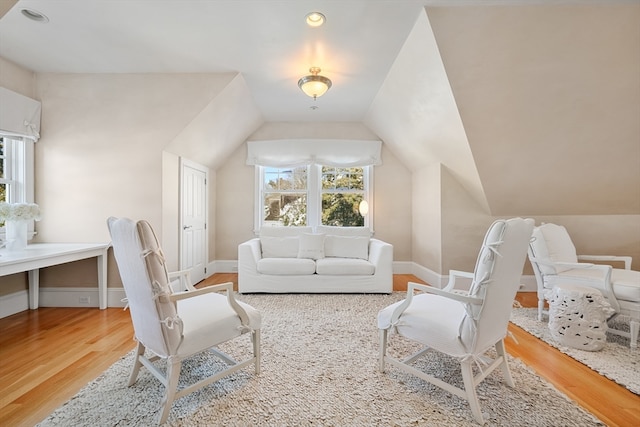 sitting room featuring lofted ceiling and light hardwood / wood-style floors