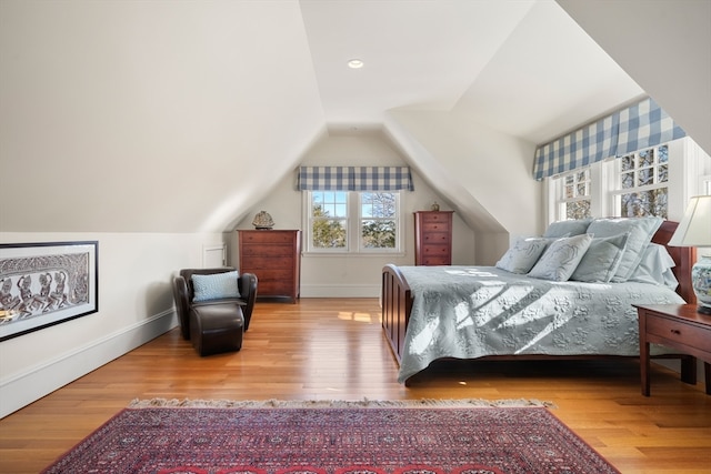 bedroom featuring light hardwood / wood-style floors and vaulted ceiling