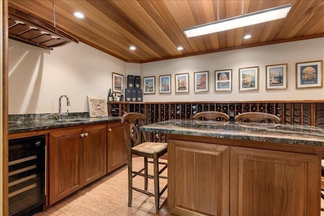 interior space with crown molding, wood ceiling, dark stone countertops, and beverage cooler