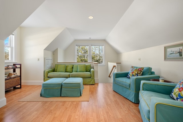 living room with vaulted ceiling and light wood-type flooring