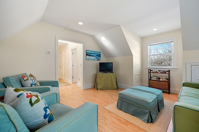 living room featuring light wood-type flooring and vaulted ceiling