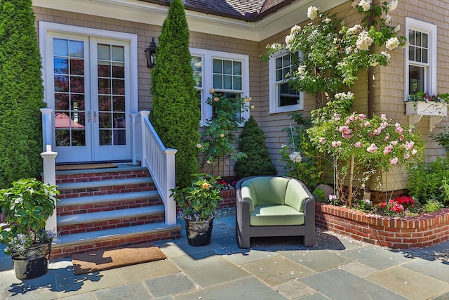 view of exterior entry featuring a patio and french doors