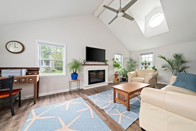 11 Brunswick St, Marshfield, MA 02050 - living area with high vaulted ceiling, beam ceiling, ceiling fan, wood finished floors, and a glass covered fireplace