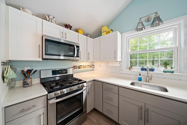 11 Brunswick St, Marshfield, MA 02050 - kitchen featuring appliances with stainless steel finishes, a sink, gray cabinets, light countertops, and vaulted ceiling