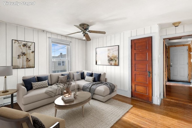 living room featuring ceiling fan, light wood-type flooring, and a baseboard radiator