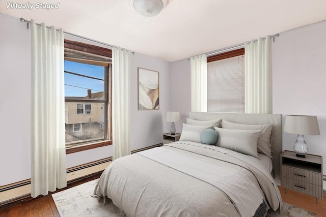 bedroom featuring dark hardwood / wood-style flooring and a baseboard radiator