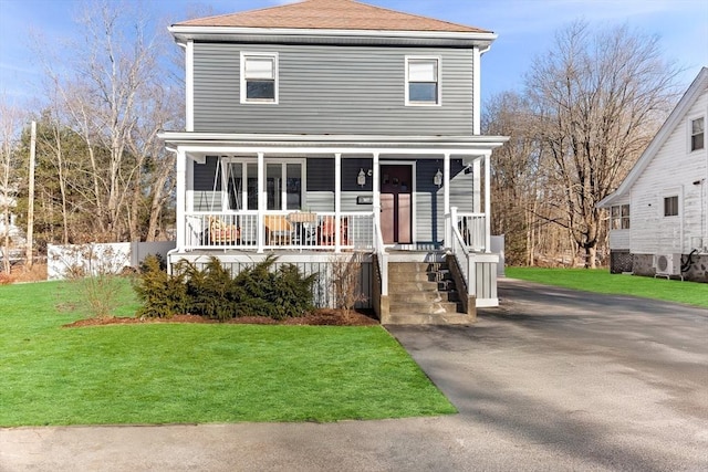 front facade featuring a front yard and covered porch