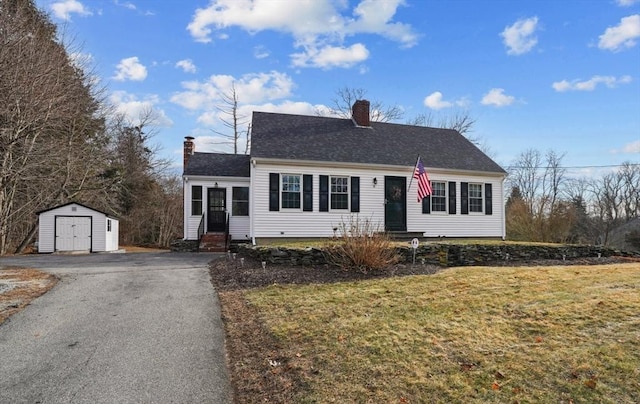 view of front of property with a front yard and a shed