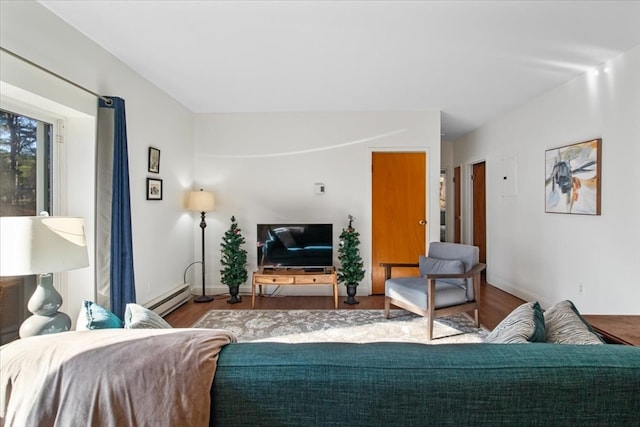 living room featuring baseboard heating and wood-type flooring