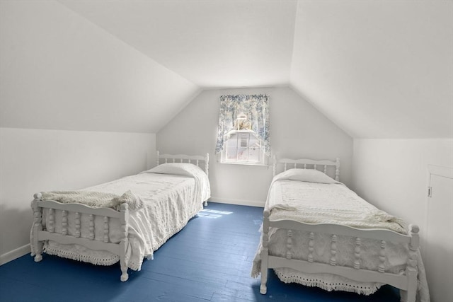 bedroom featuring baseboards, vaulted ceiling, and hardwood / wood-style floors