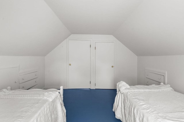 bedroom with carpet and lofted ceiling