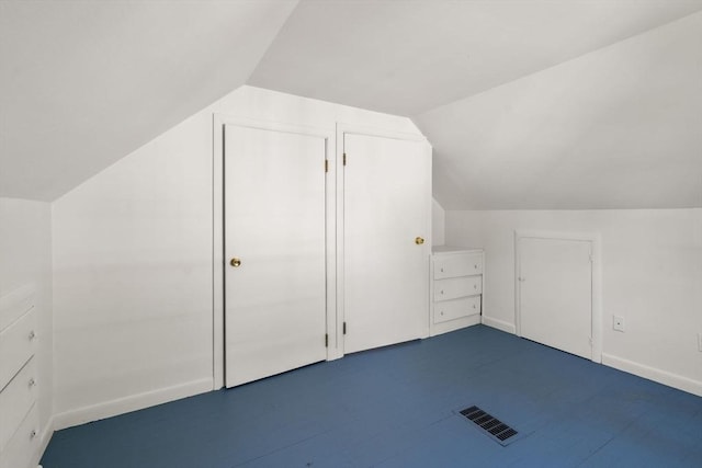 additional living space featuring visible vents, baseboards, and lofted ceiling