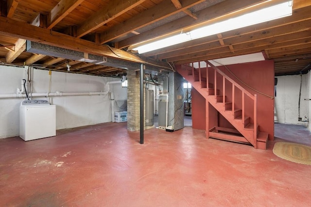 unfinished basement with heating unit, washer / clothes dryer, stairs, and gas water heater