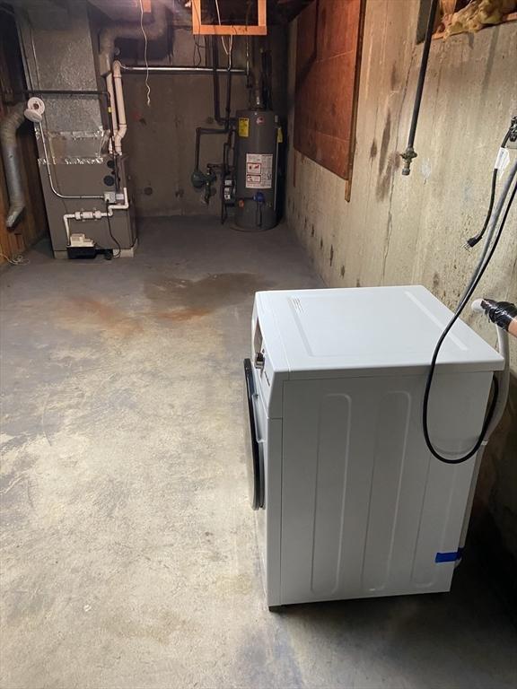 62 Duncan Rd, Stoughton, MA 02072 - unfinished below grade area featuring gas water heater, washer / clothes dryer, and heating unit