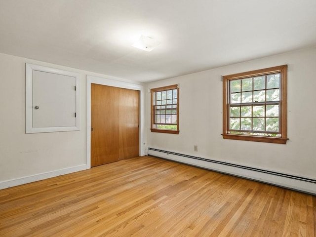 51 Quaboag Rd, Acton, MA 01720 - unfurnished bedroom featuring baseboard heating, light wood-type flooring, and a closet