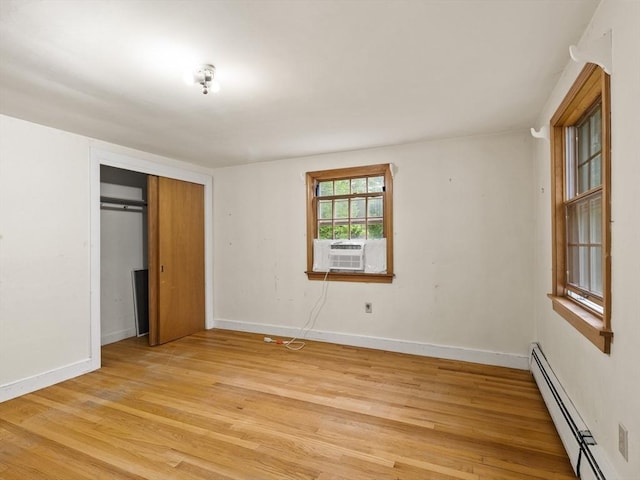 51 Quaboag Rd, Acton, MA 01720 - unfurnished bedroom featuring baseboard heating, light wood-style flooring, a closet, and cooling unit