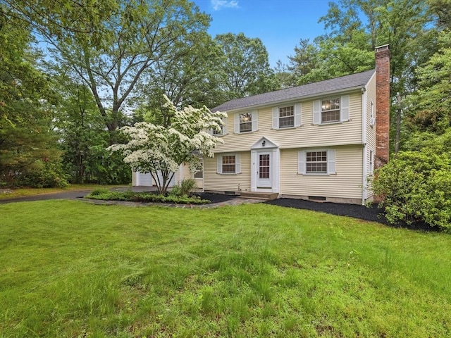 51 Quaboag Rd, Acton, MA 01720 - colonial home featuring a chimney, a front yard, and a garage