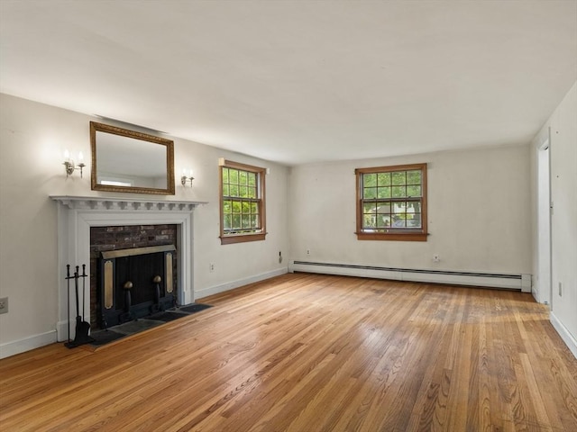 51 Quaboag Rd, Acton, MA 01720 - unfurnished living room with a baseboard radiator, wood finished floors, plenty of natural light, and a fireplace with flush hearth
