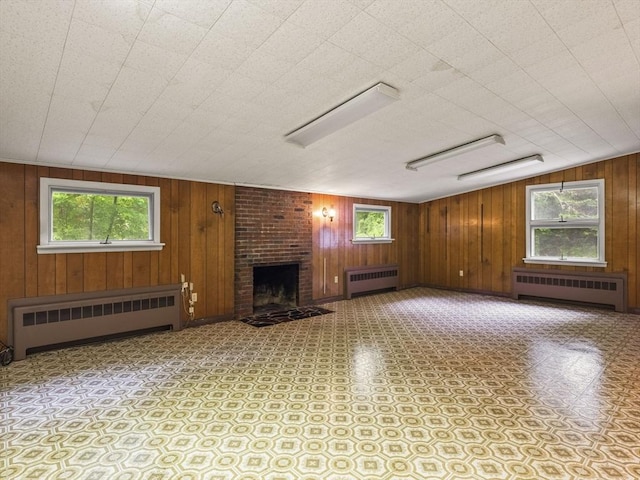 51 Quaboag Rd, Acton, MA 01720 - unfurnished living room with radiator, plenty of natural light, and wooden walls