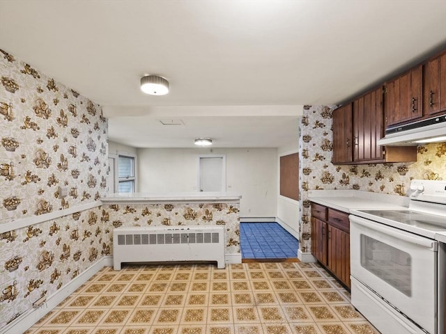 51 Quaboag Rd, Acton, MA 01720 - kitchen with white range with electric cooktop, radiator, under cabinet range hood, wallpapered walls, and light countertops