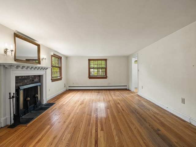 51 Quaboag Rd, Acton, MA 01720 - unfurnished living room with baseboard heating, wood finished floors, and a fireplace with flush hearth
