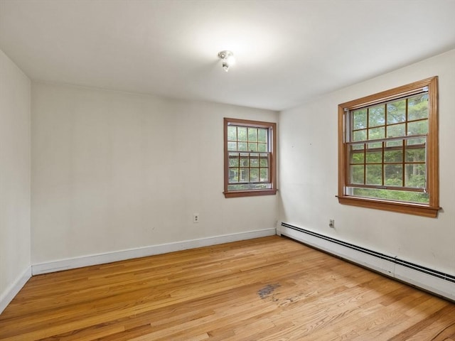 51 Quaboag Rd, Acton, MA 01720 - spare room with a baseboard heating unit, light wood-style flooring, and healthy amount of natural light