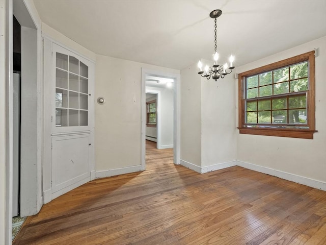51 Quaboag Rd, Acton, MA 01720 - unfurnished dining area featuring a chandelier, healthy amount of natural light, and wood finished floors