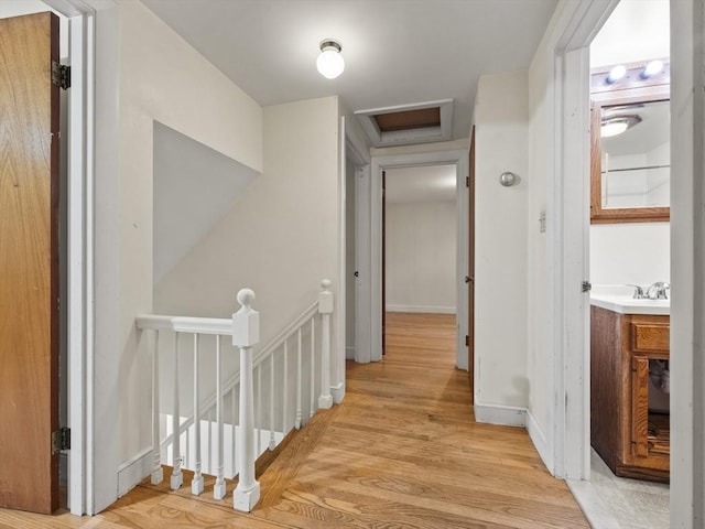 51 Quaboag Rd, Acton, MA 01720 - hallway featuring an upstairs landing, light wood finished floors, and attic access