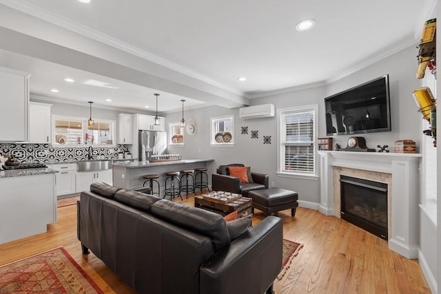 57 Railroad Ave Unit C1, Salisbury, MA 01952 - living room with a wall mounted air conditioner, light wood-type flooring, a glass covered fireplace, recessed lighting, and ornamental molding